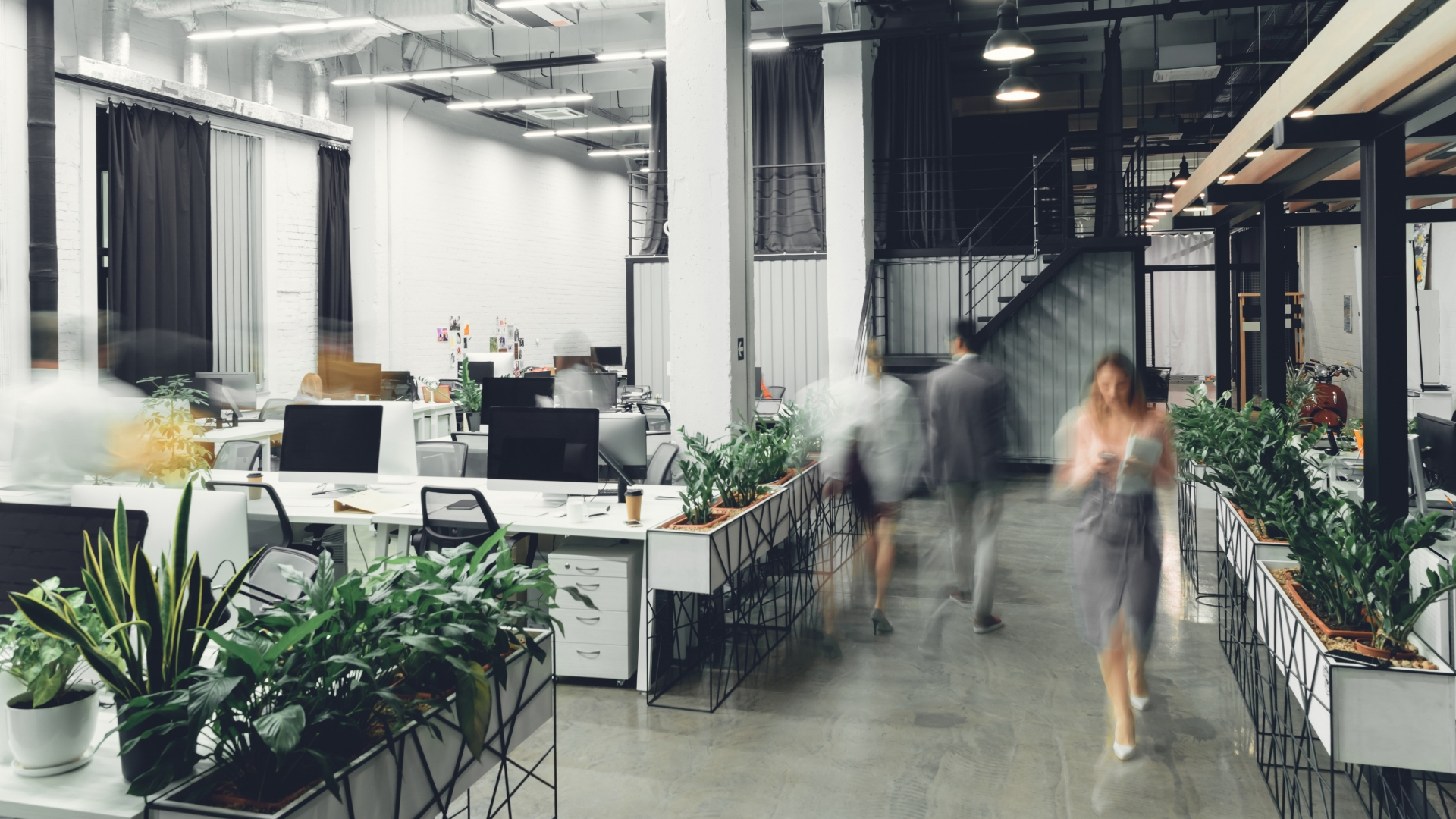 Various people walking through an office space